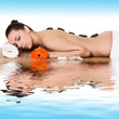Beautiful woman with hot stones on her back