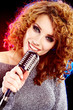 Foto: woman holding a retro microphone woman holding a retro microphone