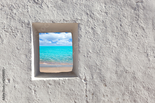 Photo: Balearic islands idyllic turquoise beach from house window Balearic islands idyllic turquoise beach from house window