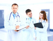 Portrait doctor smiling with colleagues in background