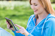 Woman using digital tablet outdoors