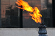 closeup torch flame at mausoleum over blurred background
