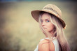 portrait of the rural girl in a straw hat