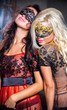 Photo: Dance happy young girls under masks on the party Dance happy young girls under masks on the party