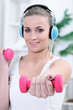 Woman exercising with dumbbells at home