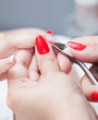 Foto: Nail salon - Cut cuticle on the female forefinger Nail salon - Cut cuticle on the female forefinger