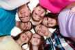 Photo: group of smiling friends with their heads together group of smiling friends with their heads together
