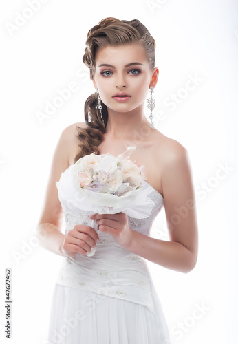 Photo: Happy beautiful bride with bouquet of wedding flowers Happy beautiful bride with bouquet of wedding flowers