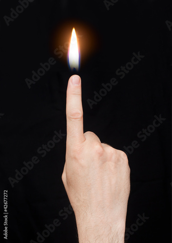 Photo: The hand with the flame at the end of the finger The hand with the flame at the end of the finger