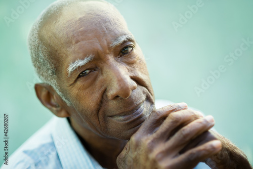 Photo: Closeup of happy old black man smiling at camera Closeup of happy old black man smiling at camera