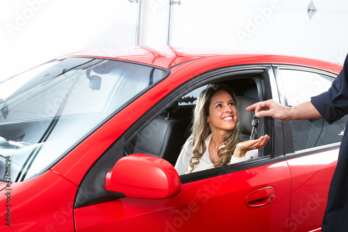 Photo: Auto mechanic and a client woman. Auto mechanic and a client woman.