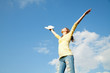 Young woman staying with raised hands