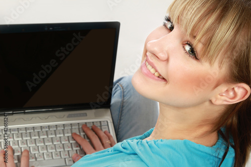 Photo: A young woman with a laptop, isolated on white, from above A young woman with a laptop, isolated on white, from above