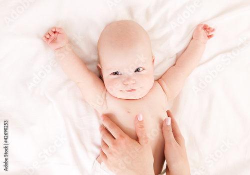 Photo: Mother massaging baby Mother massaging baby
