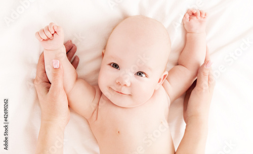 Photo: Mother massaging baby Mother massaging baby
