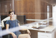 Portrait of confident businesswoman sitting at desk in office