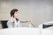 Smiling businesswoman talking on telephone in office