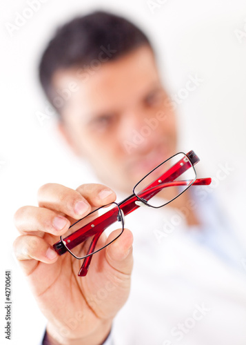 Photo: Man holding glasses Man holding glasses