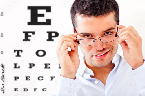 Photo: Man taking an eye exam Man taking an eye exam