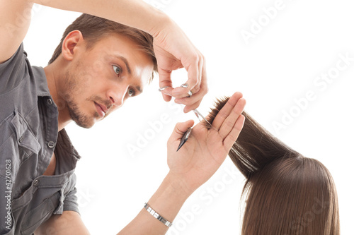 Photo: Professional hairdresser with long hair model, isolated on white Professional hairdresser with long hair model, isolated on white