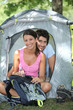 Couple sitting in front of their tent