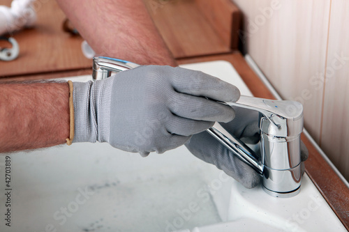 Photo: Plumber fixing a sink Plumber fixing a sink