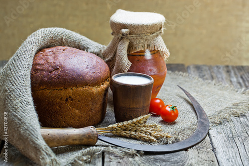 Photo: Composition of milk on the bread, the old background Composition of milk on the bread, the old background