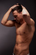 Foto : young muscular man with a bare chested on black. young muscular man with a bare chested on black.