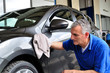 Man cleaning a car.