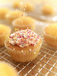 Sprinkles falling on frosted cupcake