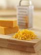 Close up of shredded cheese on cutting board