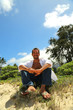 young male smiling tropical setting
