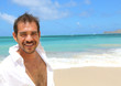 handsome man smiling at beach