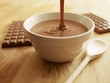 Melted chocolate pouring into bowl