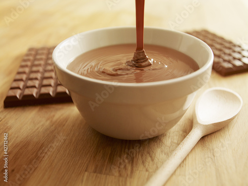 Photo: Melted chocolate pouring into bowl Melted chocolate pouring into bowl