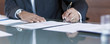 Businessman signing contract at table