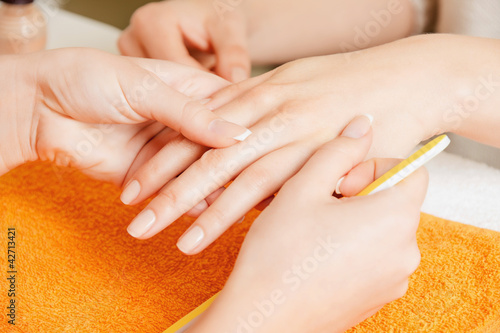 Photo: manicure process on female hands manicure process on female hands
