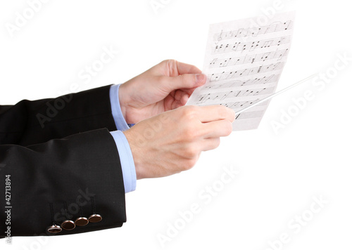 Photo: Music conductor hands with baton and notes isolated on white Music conductor hands with baton and notes isolated on white