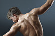 Rear view of bare chested man with arms outstretched