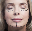 Close up portrait of woman with eyes closed and dotted lines on face