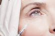 Close up of woman receiving botox injection under eye