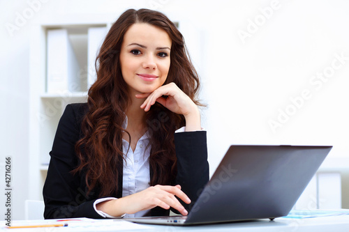 Photo: Young busines woman with notebook Young busines woman with notebook