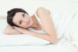 Sweet dreams: young caucasian woman relaxing in bed