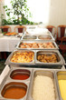 Foto: Hot buffet meal displayed in metal dishes Hot buffet meal displayed in metal dishes
