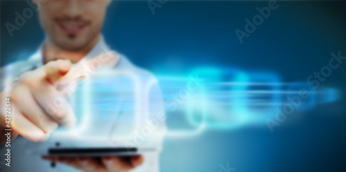 Photo: Man working with virtual interface on blue digital background Man working with virtual interface on blue digital background