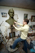 Sculptor works in studio with model of bust of Suvorov