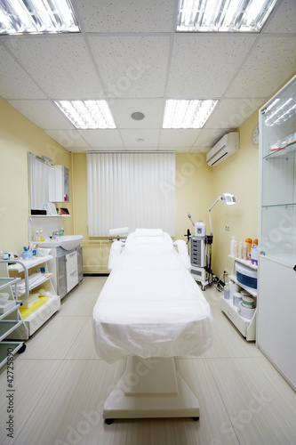 Photo: Cosmetic couch and other equipment in cabinet in beauty salon Cosmetic couch and other equipment in cabinet in beauty salon