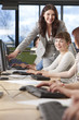 Student & Teacher Using Computers at College