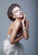 Woman actress in white dress acting on stage. Theater. Drama