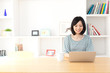 a young asian woman using laptop computer